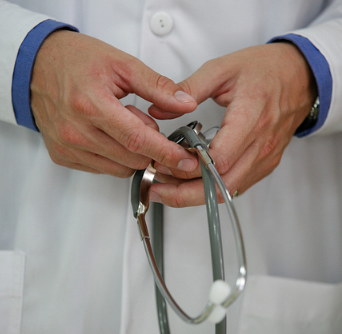 doctor's hands holding stethoscope