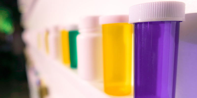 Empty prescription bottles displayed on a shelf