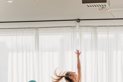 fit woman doing gymnastic exercise with fit ball