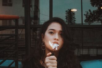 photo of woman lighting cigarette