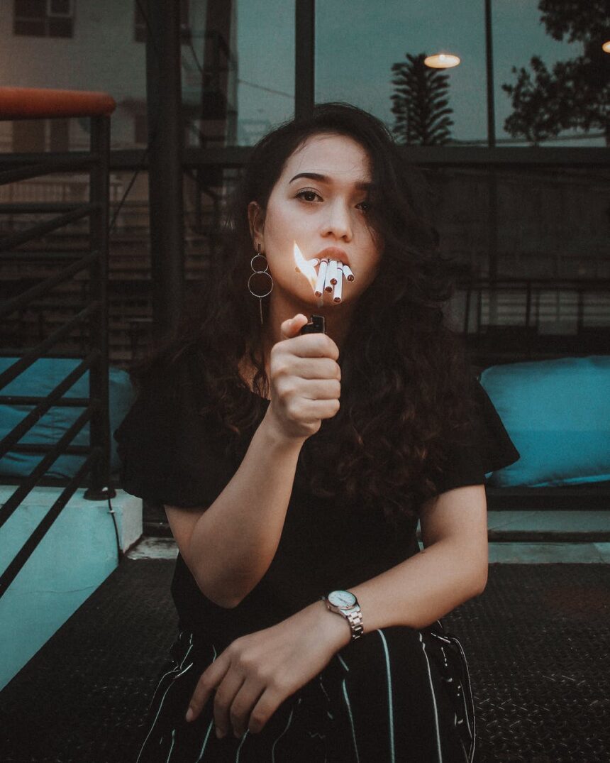 photo of woman lighting cigarette