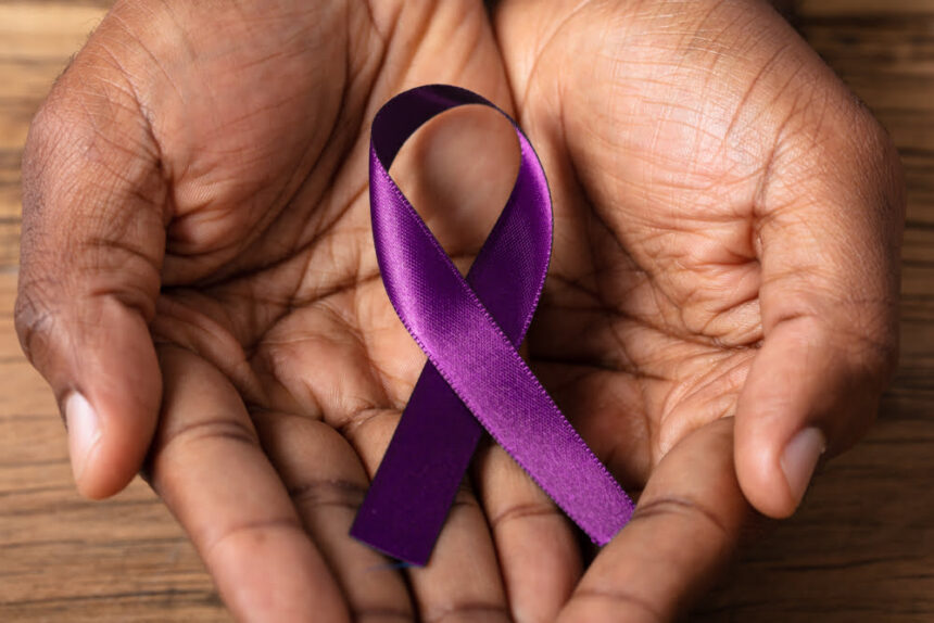 Close-up,Of,A,Person's,Hand,Holding,Ribbon,To,Support,Alzheimer's