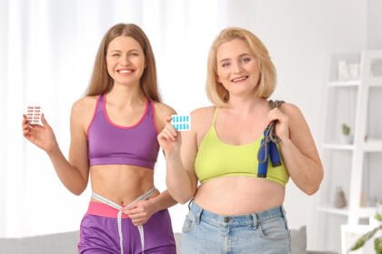 Woman with weight loss pills, jumping rope and measuring tape at