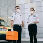 paramedics in surgical gloves and masks