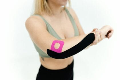 a woman with kinesio tapes on her back arm