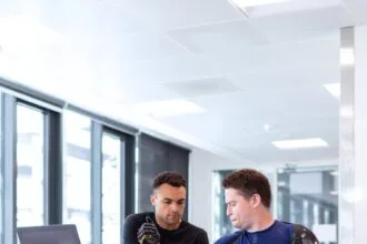 engineer fitting prosthetic arm