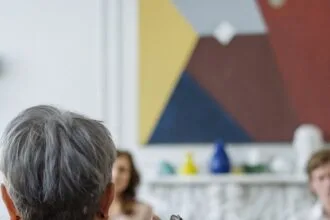 man in black suit jacket using smartphone