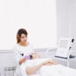 a cosmetologist doing beauty treatment to a woman