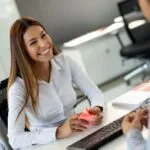 Beautiful woman manager communicates with the client in the work