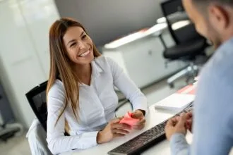Beautiful woman manager communicates with the client in the work