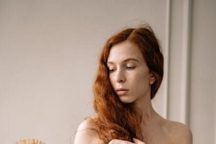 photo of a woman with red hair holding a brown brush
